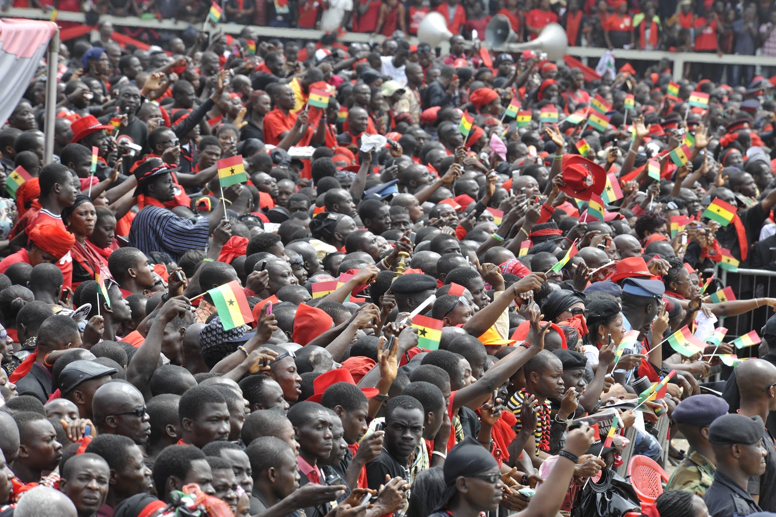 crowd in Ghana, holding flags